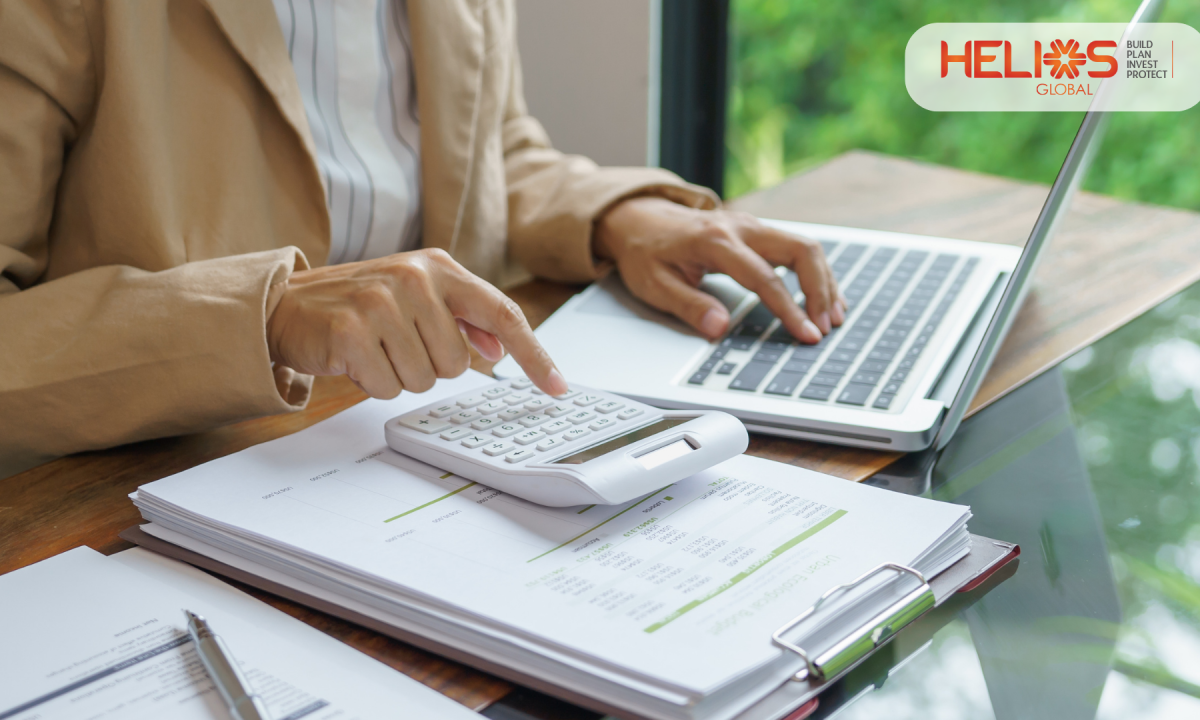 Professional reviewing website development costs and financial documents using a calculator and laptop at a modern workspace, representing budgeting and planning for WordPress website development in India.
